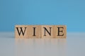 Wine word written on wood cube with blue background Royalty Free Stock Photo