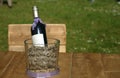 Winebottle on a wooden desk with wooden chair