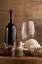 Wineglass by bottle with spice and bread on table Royalty Free Stock Photo