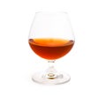 Wineglass with cognac isolated on white background