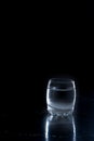 Wineglass frozen Vodka on black background