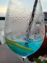 wineglass , lemon, blue Lagoon, drops