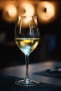 Wineglass with a white wine on a table Royalty Free Stock Photo