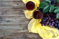 Wineglasses with red wine, bottle, corkscrew, blue grapes, leaves on a wooden table. Wine background with copy space. Top view, Royalty Free Stock Photo