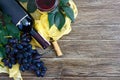 Wineglasses with red wine, bottle, corkscrew, blue grapes, leaves on a wooden table. Wine background with copy space. Top view, Royalty Free Stock Photo