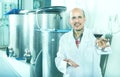 Winemaker examining sample of wine Royalty Free Stock Photo