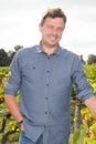 winemaker man standing at vineyard on sunny day