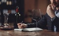 Winemaker sommelier man sniffing aroma red wine in glass