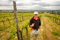 Winemaker standing in his vineyard near Montalcino, Val d`Orcia,