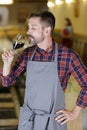 Winemaker tasting red wine in cellar Royalty Free Stock Photo