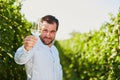 Winemaker tasting white wine in vineyard