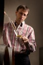 Winemaker testing white wine in cellar. Royalty Free Stock Photo