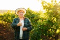 winemaker woman with hat showing thumb up and looking at camera