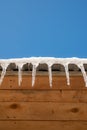 Winer weather. Icicles. Frozen winter icon background. Icicles hanging from house roof. Close-up of ice. Building