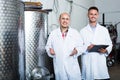 Winery workers standing in fermenting section Royalty Free Stock Photo