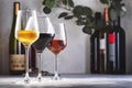 Wines assortment. Red, white, rose wine in glasses and bottles on gray table background. Wine bar, shop, tasting concept