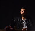 Winetasting and degustation concept. Sommelier tastes expensive drink. Man with beard holds wine glass Royalty Free Stock Photo