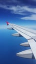 Wing of aeroplane over blue sky ideal for travel concept Royalty Free Stock Photo