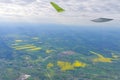 The wing of an airborne aircraft over land and water. sunny weather. beautiful view