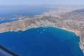 The wing of an airborne aircraft over land and water. sunny weather. beautiful view