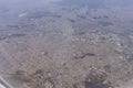 The wing of an airborne aircraft over land and water. sunny weather. beautiful view