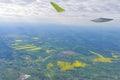 The wing of an airborne aircraft over land and water. sunny weather. beautiful view