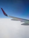 Wing from Aircraft above the clouds Royalty Free Stock Photo