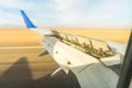 The wing of an aircraft with open flaps on the wing that is landing. The wing of a passenger aircraft with air brakes Royalty Free Stock Photo