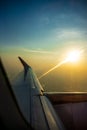 The wing of airplan in front of sunset time flying Royalty Free Stock Photo