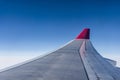 Wing of airplane from Air in the sky winglet red colored airline blue sky clouds Royalty Free Stock Photo