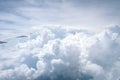 Wing of airplane flying above the clouds in the blue sky background through the window. Royalty Free Stock Photo