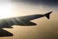 Wing of an airplane flying above the clouds. Royalty Free Stock Photo