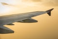 Wing of an airplane flying above the clouds. Royalty Free Stock Photo