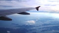 Wing of an airplane flying above the clouds with sunset sky. Aircraft. Royalty Free Stock Photo