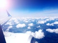 Wing of an airplane flying above the clouds. Travel concept. View from plane Royalty Free Stock Photo