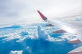 Wing of an airplane flying above the clouds view Royalty Free Stock Photo