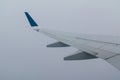 Wing of airplane in fog of clouds Royalty Free Stock Photo