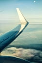 Wing of an airplane over clouds in front of Moon Royalty Free Stock Photo