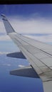 Wing of an airplane, passenger s view. Looking through the window of a plane on its shining wing Royalty Free Stock Photo