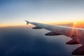 The wing of a airplane at sunset