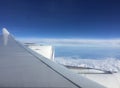 The wing of an ariplane with two large motors and a view over the a beautiful cloudscape with a blue sky Royalty Free Stock Photo