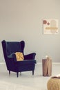 Back chair with yellow knot pillow next to stylish wooden coffee table Royalty Free Stock Photo