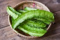 Wing bean on basket and wooden table background, young winged beans vegetable Royalty Free Stock Photo