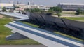 Wing braking of the aircraft on the runway. The wing of an aircraft open flaps on the wing for is landing.