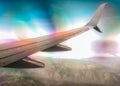 wing of a civilian airliner airplane in flight with mountains with optical effect Royalty Free Stock Photo