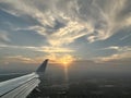The wing of a commercial airline airplane while flying high in the sky over Dallas Texas on a travel vacation Royalty Free Stock Photo