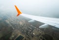 Wing of a flying civil airliner over the city of Georgia