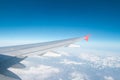 Wing of a low-cost aircraft at high altitude with a view of blue sky and clouds Royalty Free Stock Photo