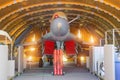 Wing military fighter with folded wings in the garage of the hangar on service repair