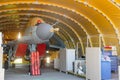 Wing military fighter with folded wings in the garage of the hangar on service repair